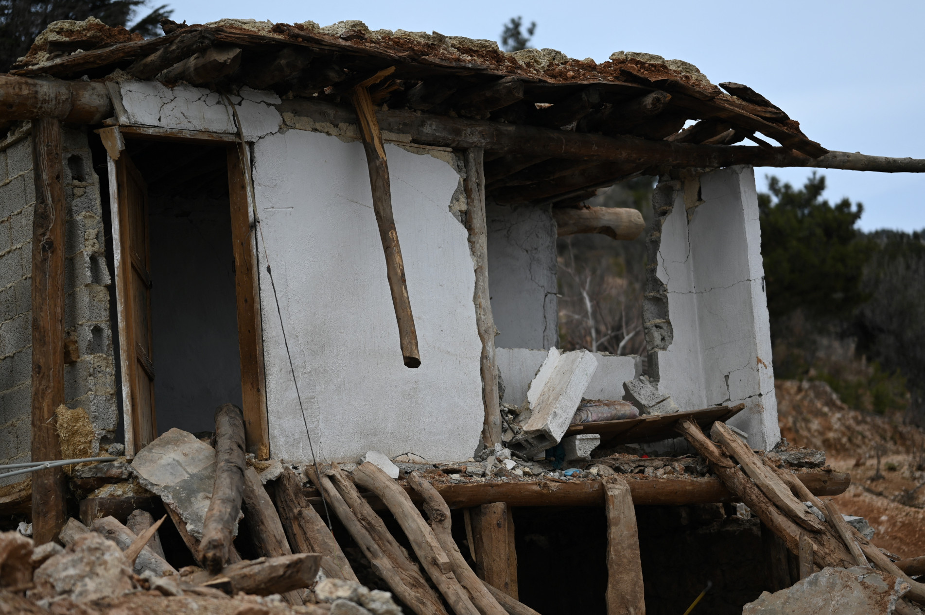  A photo shows the destroyed home of resident Sennur Sutdelisi, 37, who lost her two teenage chlidren and husband in the quake, in the village of Buyuknacar, near Pazarcik, Kahramanmaras province, on March 5, 2023, one month after a massive earthquake struck southeast Turkey. - Buyuknacar, a remote village home to around 2,000 people that sits on top of the mountains with a green pasture, is now almost wiped off the map after the devastating February 6 earthquake that rocked southeast Turkey and neighbouring Syria, killing over 50,000 people. There are almost no solid house left in the village only 26 kilometres (16 miles) from the 7.8 magnitude earthquake's epicentre, Pazarcik. One month on, the sense of despair, loss and grief hangs thick in this village whose survivors barely managed to escape an ineluctable fate. (Photo by Eylul YASAR / AFP)