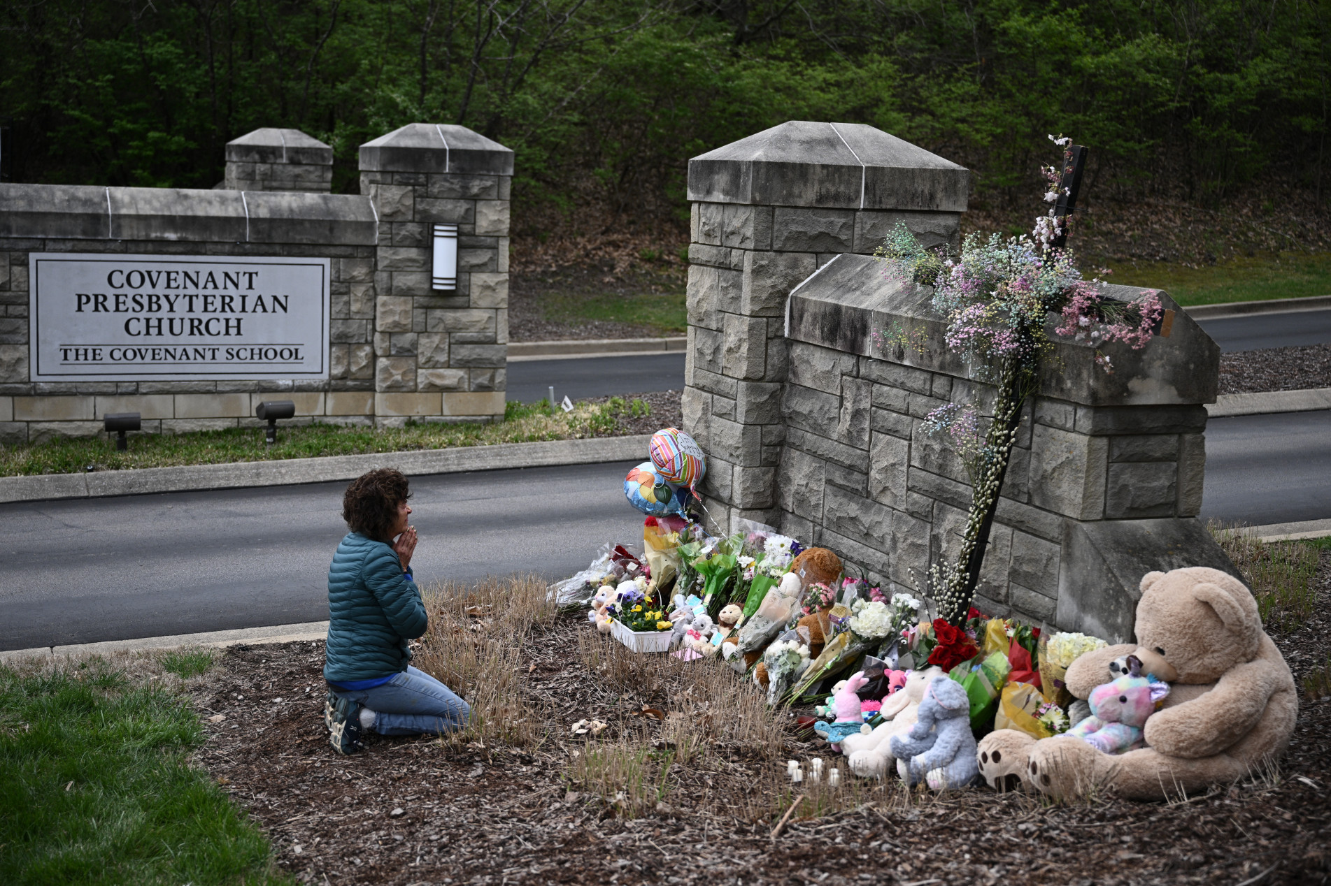  Robin Wolfenden prays at a makeshift memorial for victims outside the Covenant School building at the Covenant Presbyterian Church following a shooting, in Nashville, Tennessee, on March 28, 2023. - A heavily armed former student killed three young children and three staff in what appeared to be a carefully planned attack at a private elementary school in Nashville on March 27, before being shot dead by police.
Chief of Police John Drake named the suspect as Audrey Hale, 28, who the officer later said identified as transgender. (Photo by Brendan SMIALOWSKI / AFP)